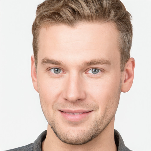 Joyful white young-adult male with short  brown hair and grey eyes