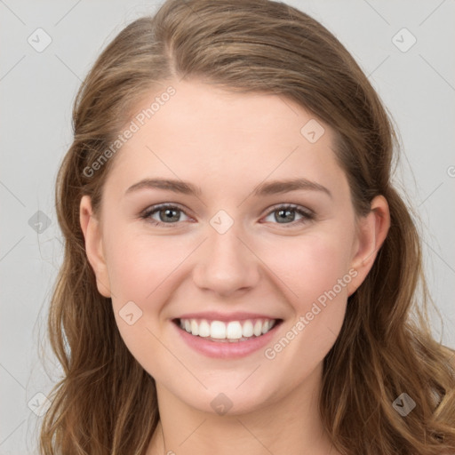 Joyful white young-adult female with long  brown hair and blue eyes