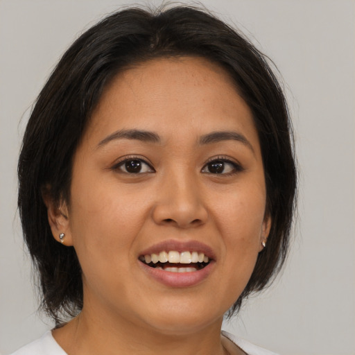 Joyful asian young-adult female with medium  brown hair and brown eyes