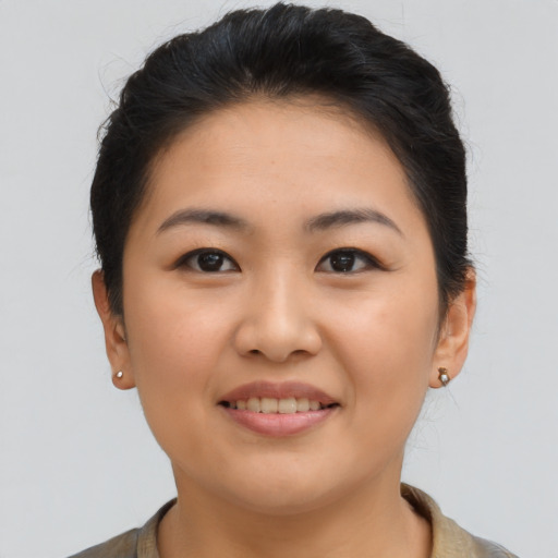 Joyful asian young-adult female with short  brown hair and brown eyes