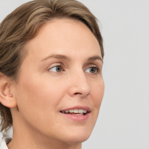 Joyful white young-adult female with medium  brown hair and green eyes