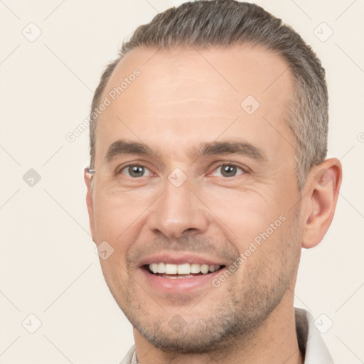 Joyful white adult male with short  brown hair and brown eyes