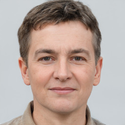 Joyful white adult male with short  brown hair and grey eyes