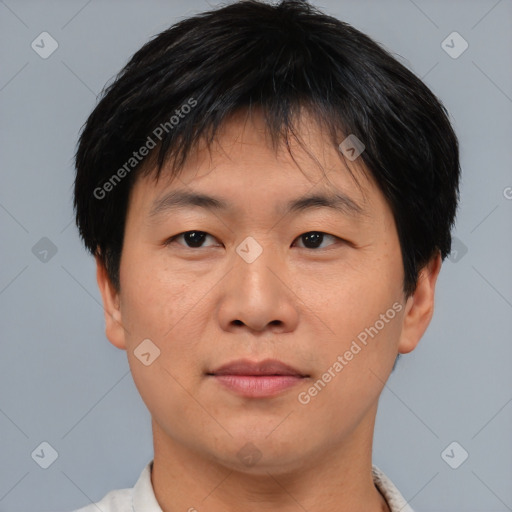 Joyful asian adult male with short  brown hair and brown eyes