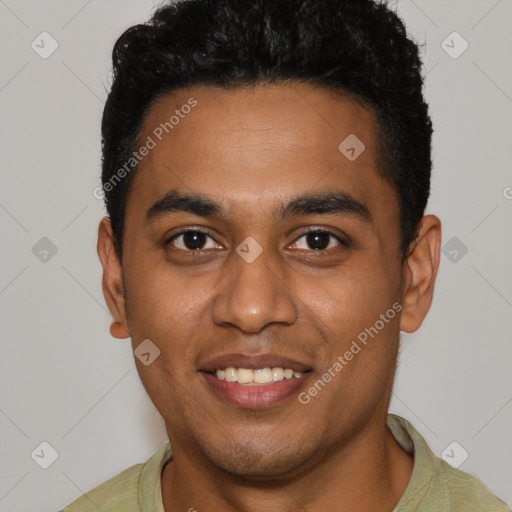 Joyful black young-adult male with short  black hair and brown eyes