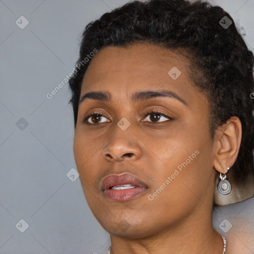 Joyful black young-adult female with short  black hair and brown eyes