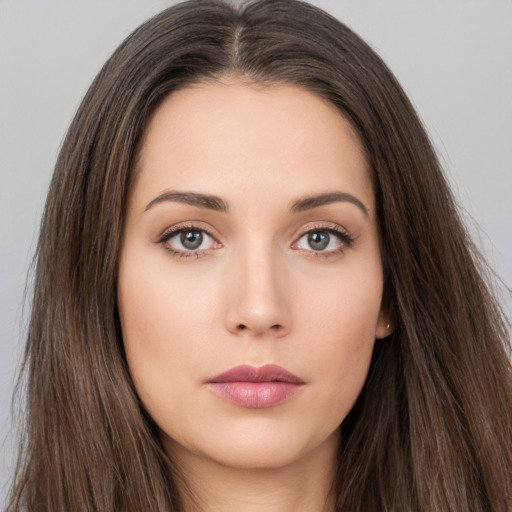 Neutral white young-adult female with long  brown hair and brown eyes