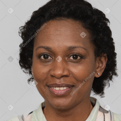 Joyful black adult female with short  brown hair and brown eyes