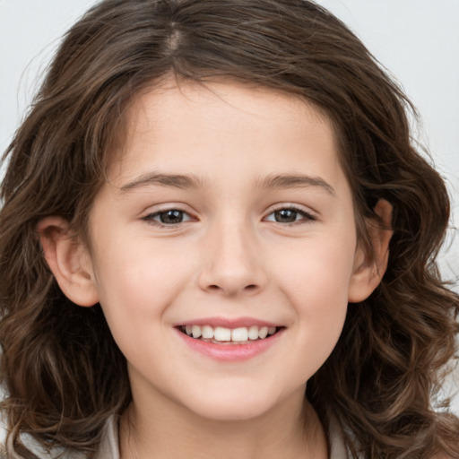 Joyful white child female with long  brown hair and brown eyes