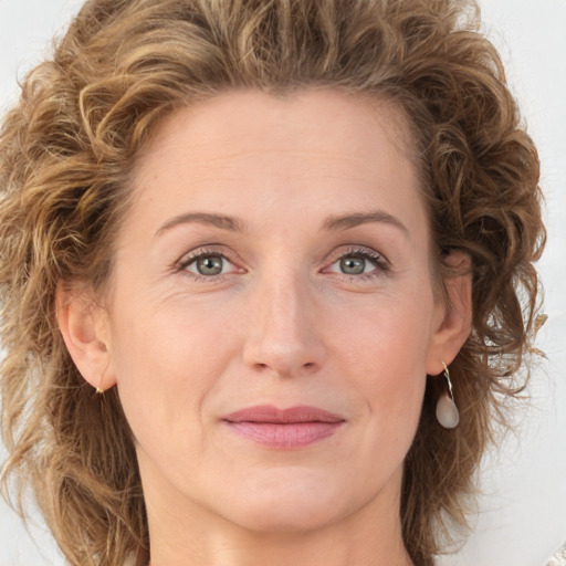 Joyful white young-adult female with medium  brown hair and green eyes