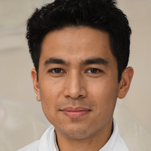 Joyful asian young-adult male with short  black hair and brown eyes