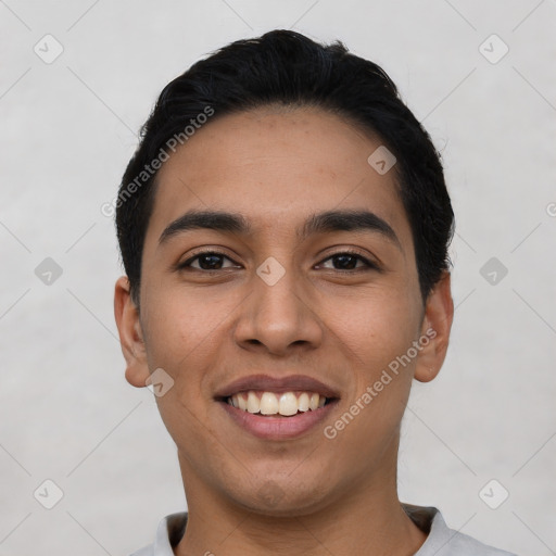 Joyful latino young-adult male with short  black hair and brown eyes