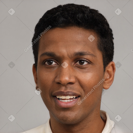 Joyful black adult male with short  black hair and brown eyes