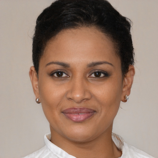 Joyful black young-adult female with short  brown hair and brown eyes