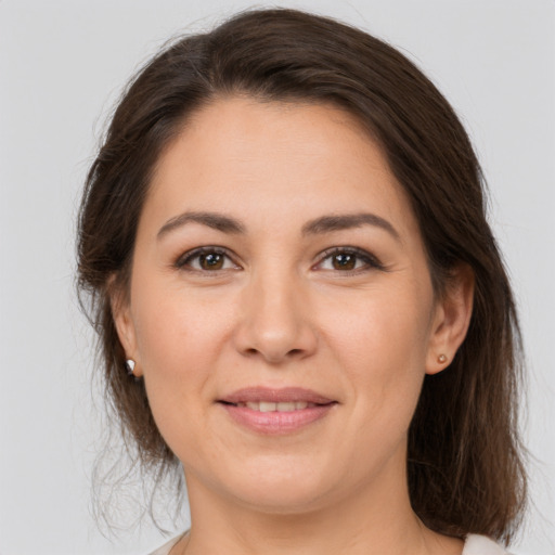 Joyful white young-adult female with medium  brown hair and brown eyes