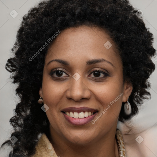 Joyful black young-adult female with long  brown hair and brown eyes