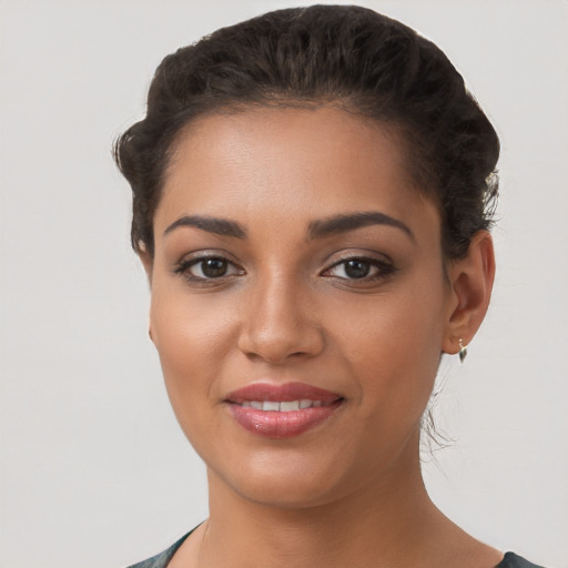 Joyful latino young-adult female with short  brown hair and brown eyes