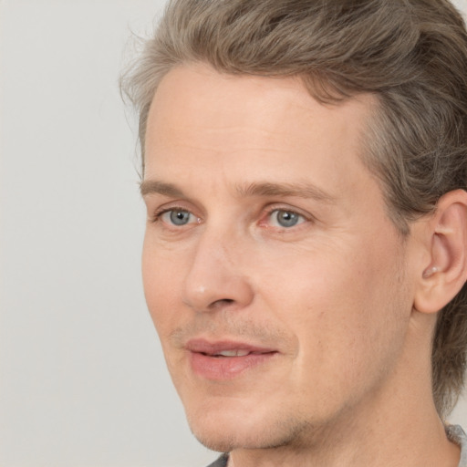 Joyful white adult male with medium  brown hair and grey eyes