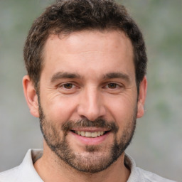 Joyful white adult male with short  brown hair and brown eyes