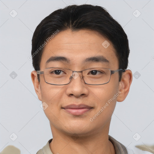 Joyful asian young-adult male with short  brown hair and brown eyes