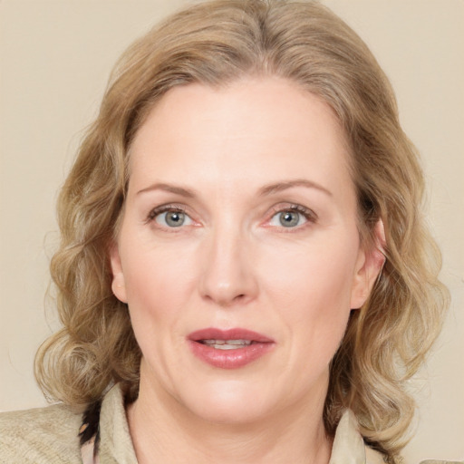 Joyful white adult female with medium  brown hair and green eyes