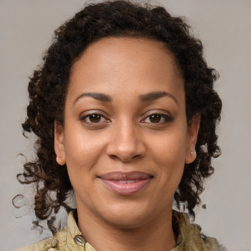 Joyful black young-adult female with medium  brown hair and brown eyes