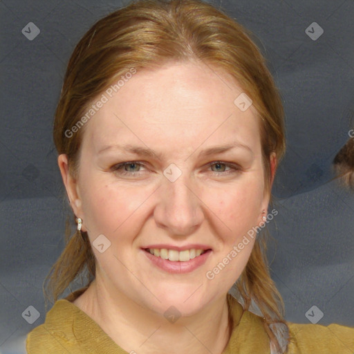 Joyful white adult female with medium  brown hair and blue eyes