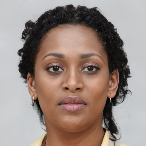 Neutral black young-adult female with long  brown hair and brown eyes