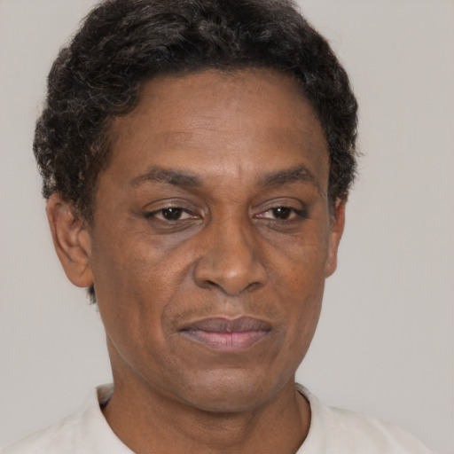 Joyful black adult male with short  brown hair and brown eyes