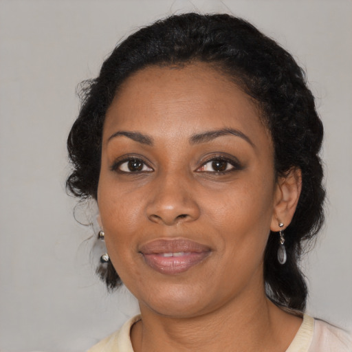Joyful black adult female with medium  black hair and brown eyes