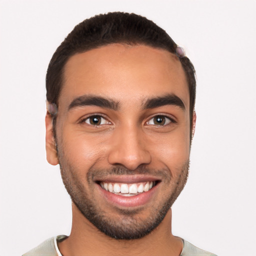 Joyful latino young-adult male with short  black hair and brown eyes