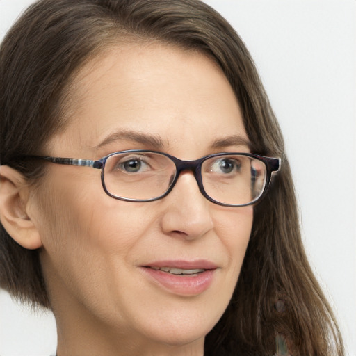 Joyful white adult female with long  brown hair and brown eyes