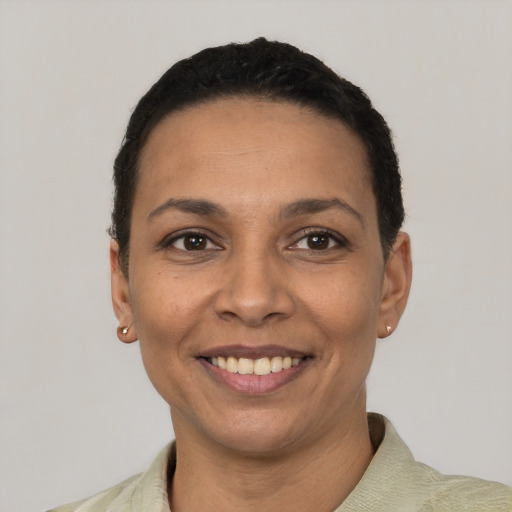 Joyful latino adult female with short  black hair and brown eyes