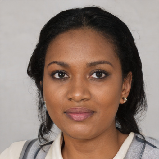 Joyful black young-adult female with medium  black hair and brown eyes