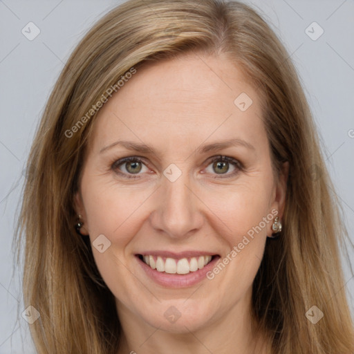 Joyful white adult female with long  brown hair and brown eyes