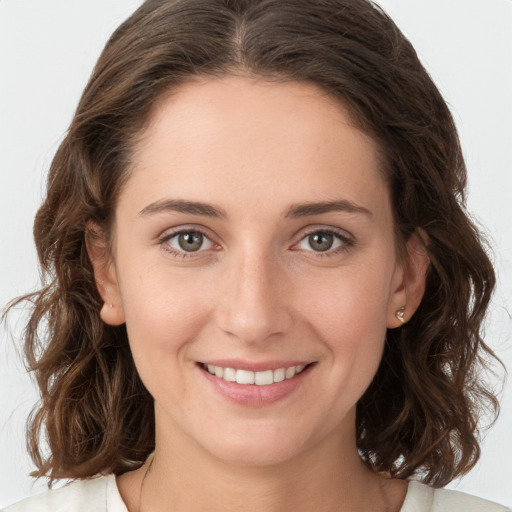 Joyful white young-adult female with medium  brown hair and green eyes