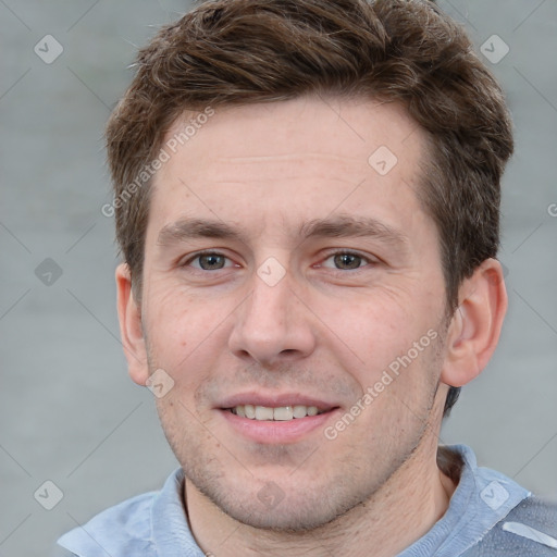 Joyful white adult male with short  brown hair and grey eyes