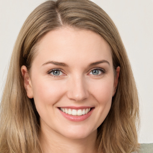 Joyful white young-adult female with long  brown hair and grey eyes