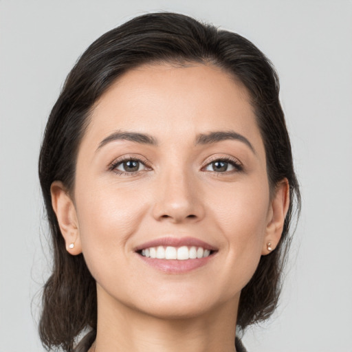 Joyful white young-adult female with medium  brown hair and brown eyes