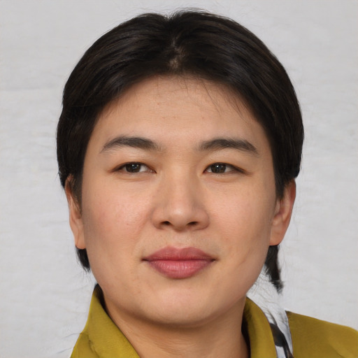 Joyful asian young-adult female with short  brown hair and brown eyes