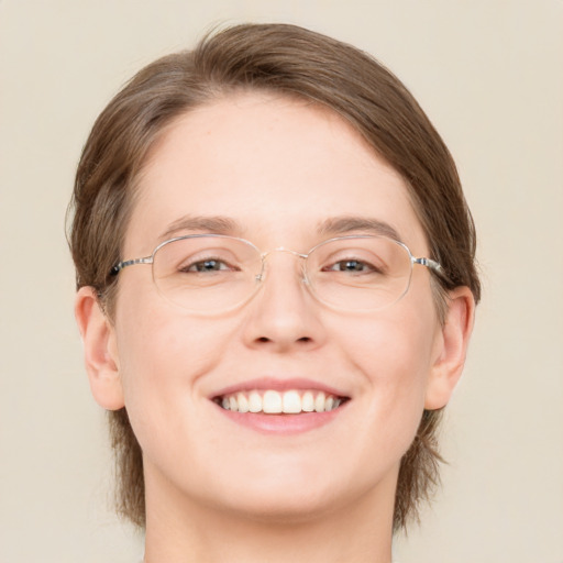 Joyful white adult female with medium  brown hair and green eyes