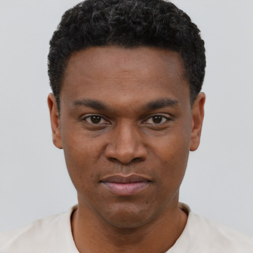 Joyful black young-adult male with short  black hair and brown eyes