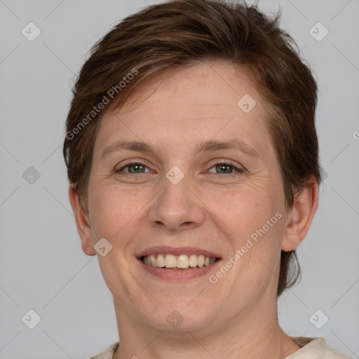 Joyful white adult female with short  brown hair and grey eyes