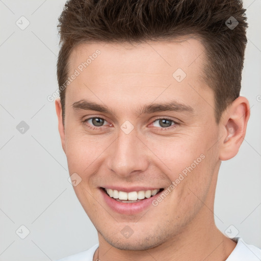 Joyful white young-adult male with short  brown hair and brown eyes