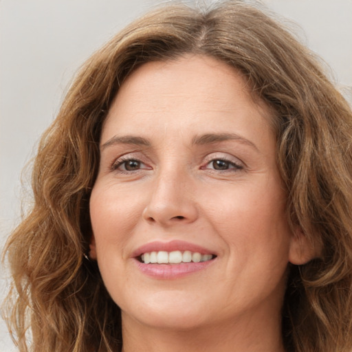 Joyful white young-adult female with long  brown hair and green eyes