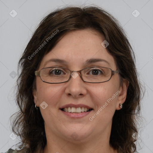 Joyful white adult female with long  brown hair and green eyes