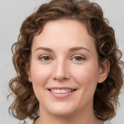 Joyful white young-adult female with medium  brown hair and green eyes