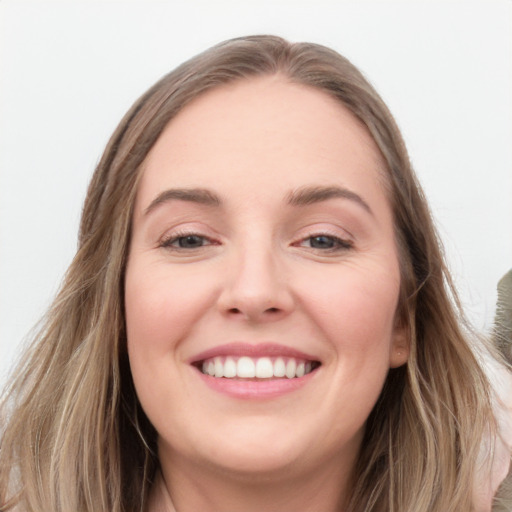 Joyful white young-adult female with long  brown hair and blue eyes