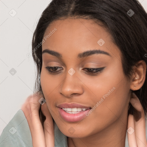 Joyful latino young-adult female with long  brown hair and brown eyes