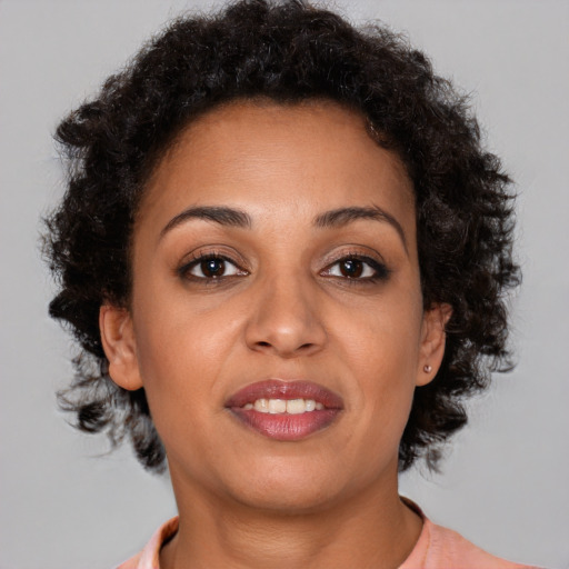 Joyful black young-adult female with short  brown hair and brown eyes